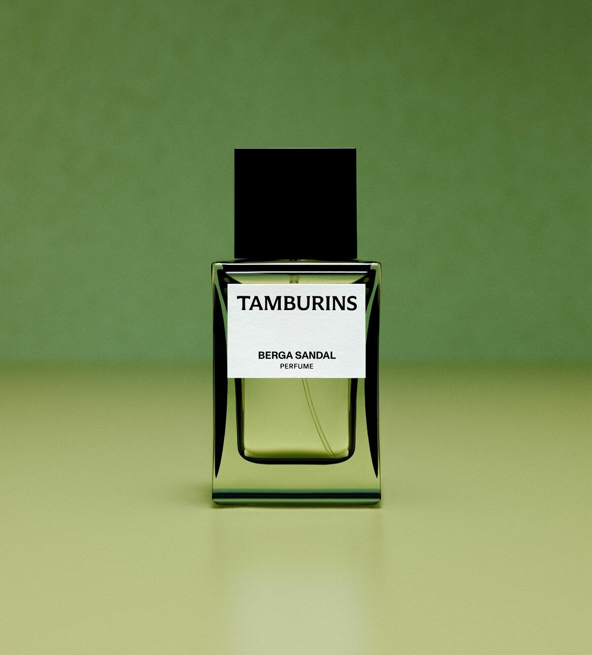 A bottle of Tamburins perfume on a table.