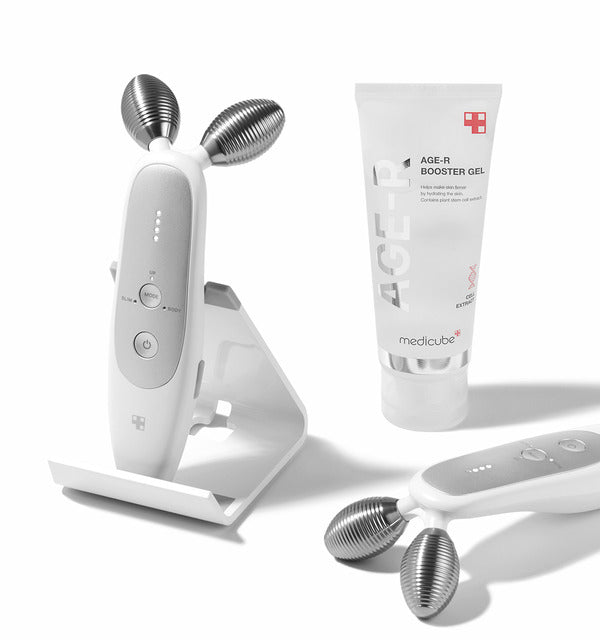 A picture displaying the Medicube AGE-R Derma EMS Shot, a device for promoting youthful skin.
