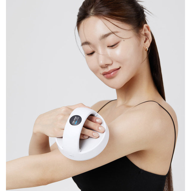 a woman holding Medicube Age-R Contour Body Shaping Device in her right arm