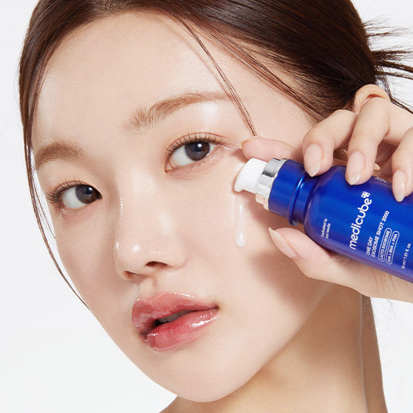 a woman is using a blue bottle of lotion