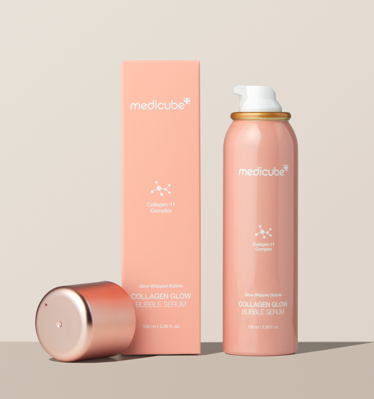 A pink bottle containing Medicube Collagen Glow Bubble Serum 100ml, a body care spray for rejuvenated skin.