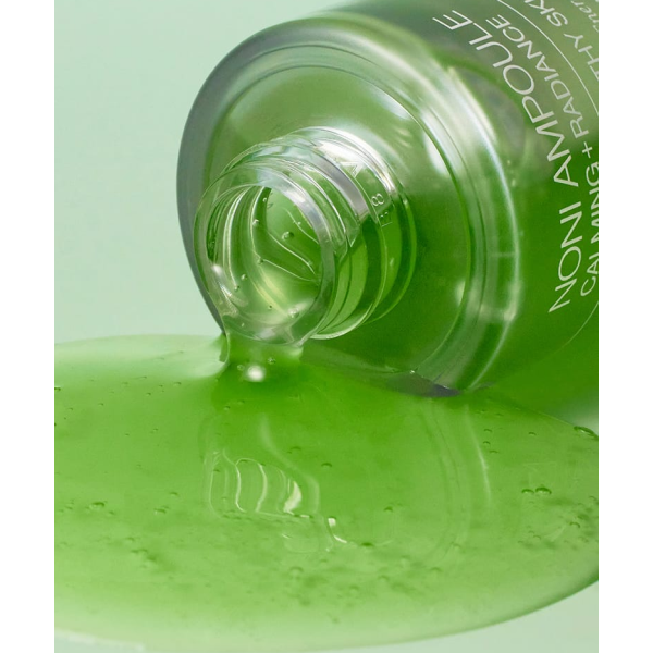 a close up of a bottle of green liquid