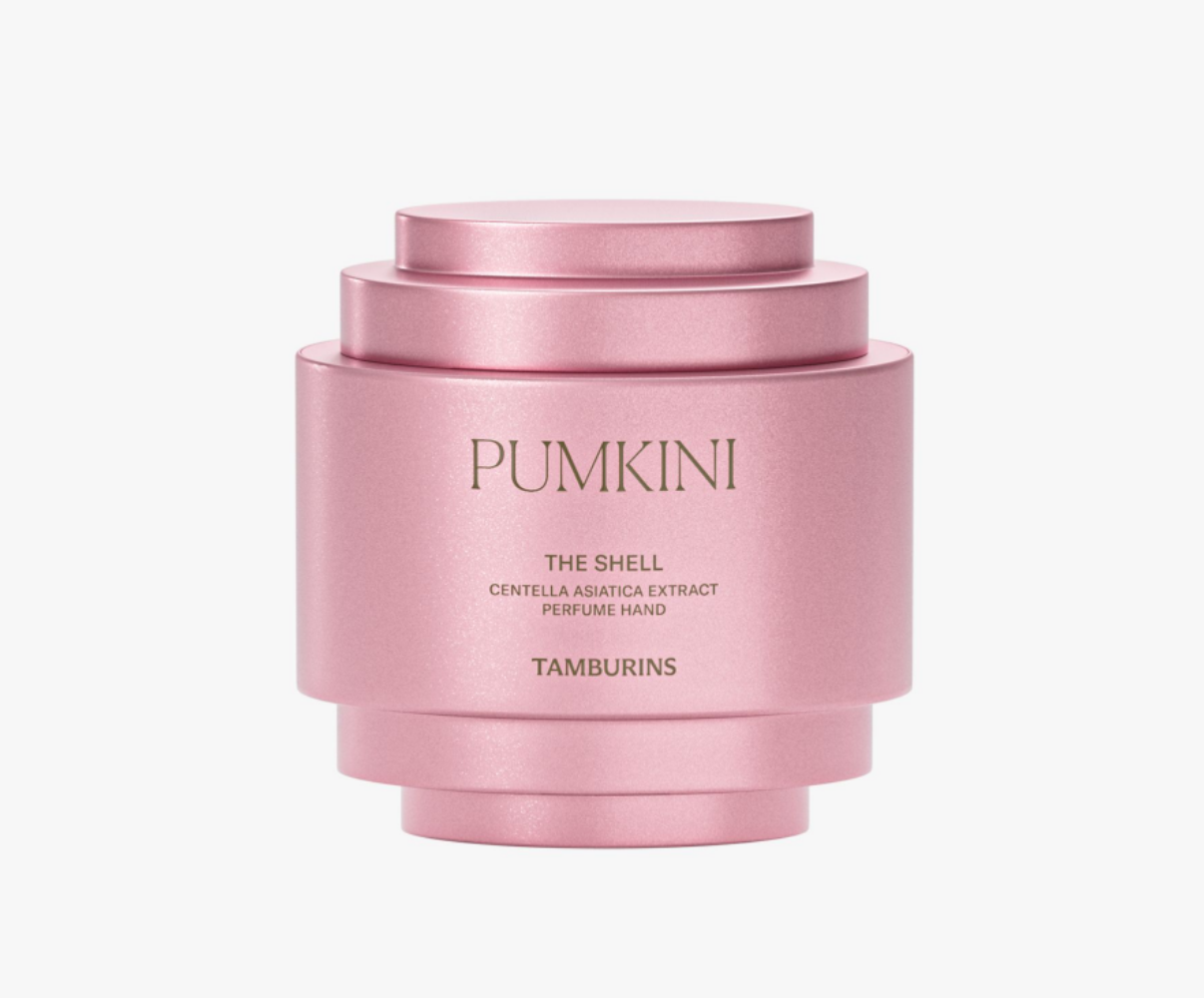 A pink face cream container with the label "TAMBURINS THE SHELL PERFUME HAND CREAM (3 TYPES) 23′ NEW", featuring Pumpkini the angel