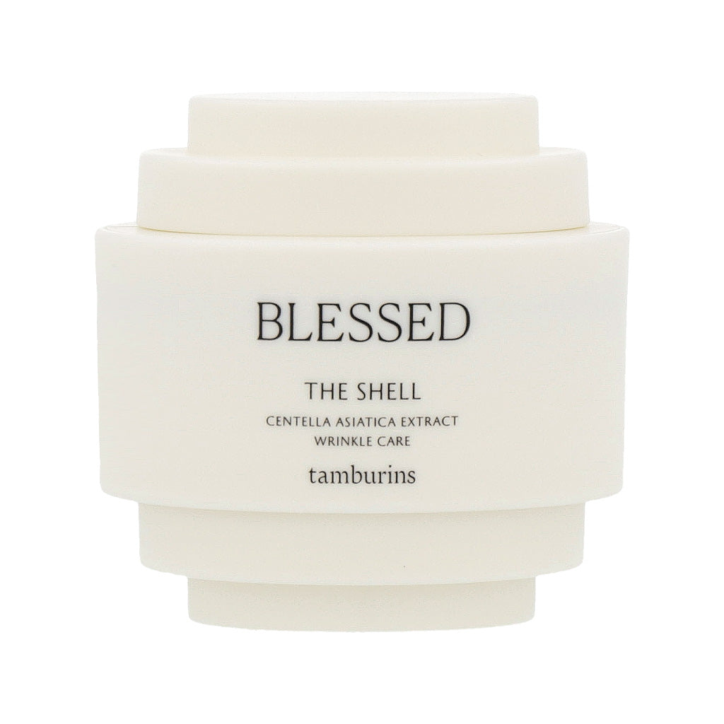 A 15ml hand cream bottle labeled "TAMBURINS THE SHELL Perfume Hand" with a blessed shell design.