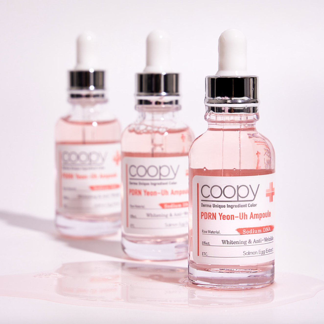  30ml COOPY PDRN Salmon Ampoule in a clear glass bottle with a pink label.