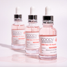  30ml COOPY PDRN Salmon Ampoule in a clear glass bottle with a pink label.