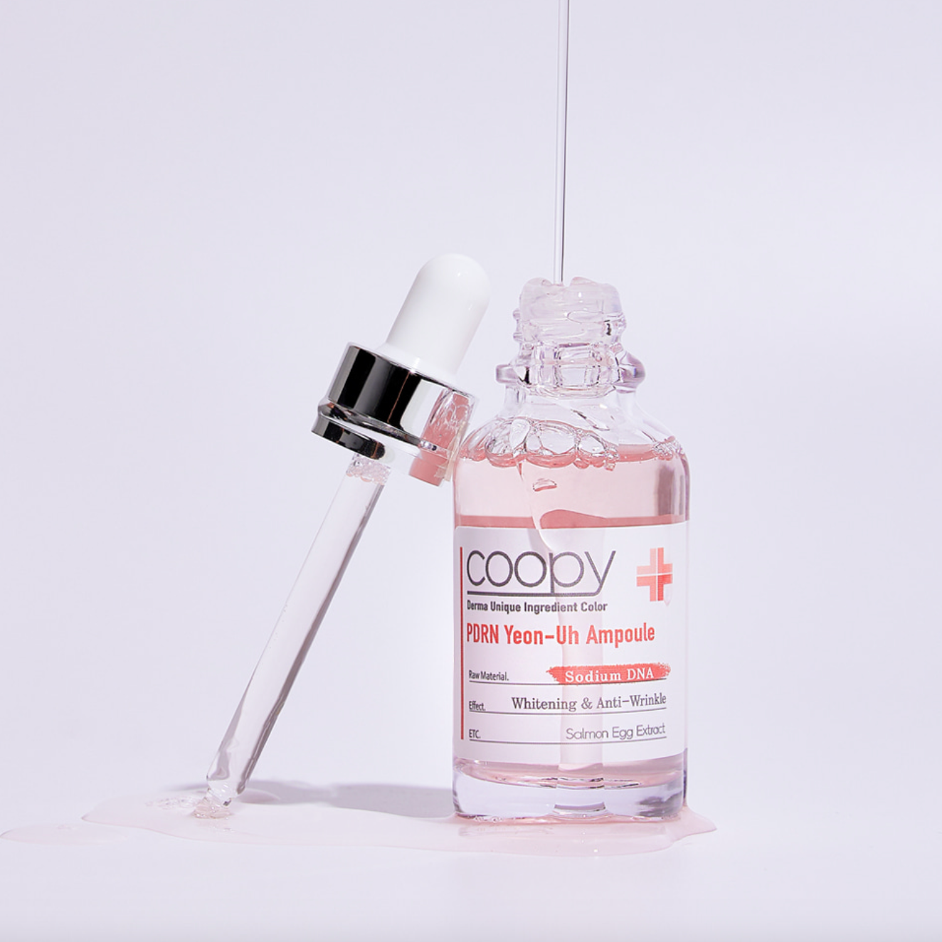  Clear glass bottle of COOPY PDRN Salmon Ampoule 30ml with pink label.