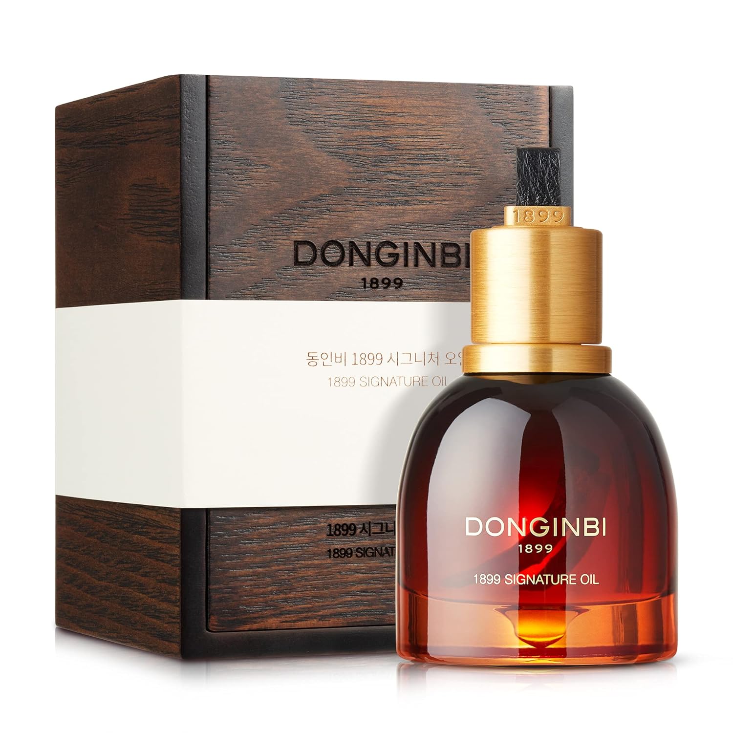 25g bottle of DONGINBI Korean Skin Care 1899 Signature Oil, featuring luxurious gold packaging.