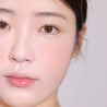 Espoir Tone Pairing Cheek 9g woman with a Peach Fizz on her cheek