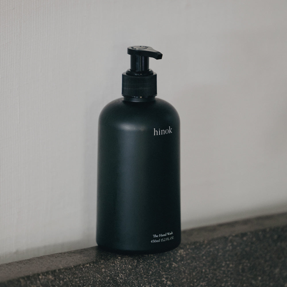 A 450ml bottle of Jeju Hinoki Cypress Hand Wash, showcasing a modern design, perfect for nourishing and fragrant hand care.