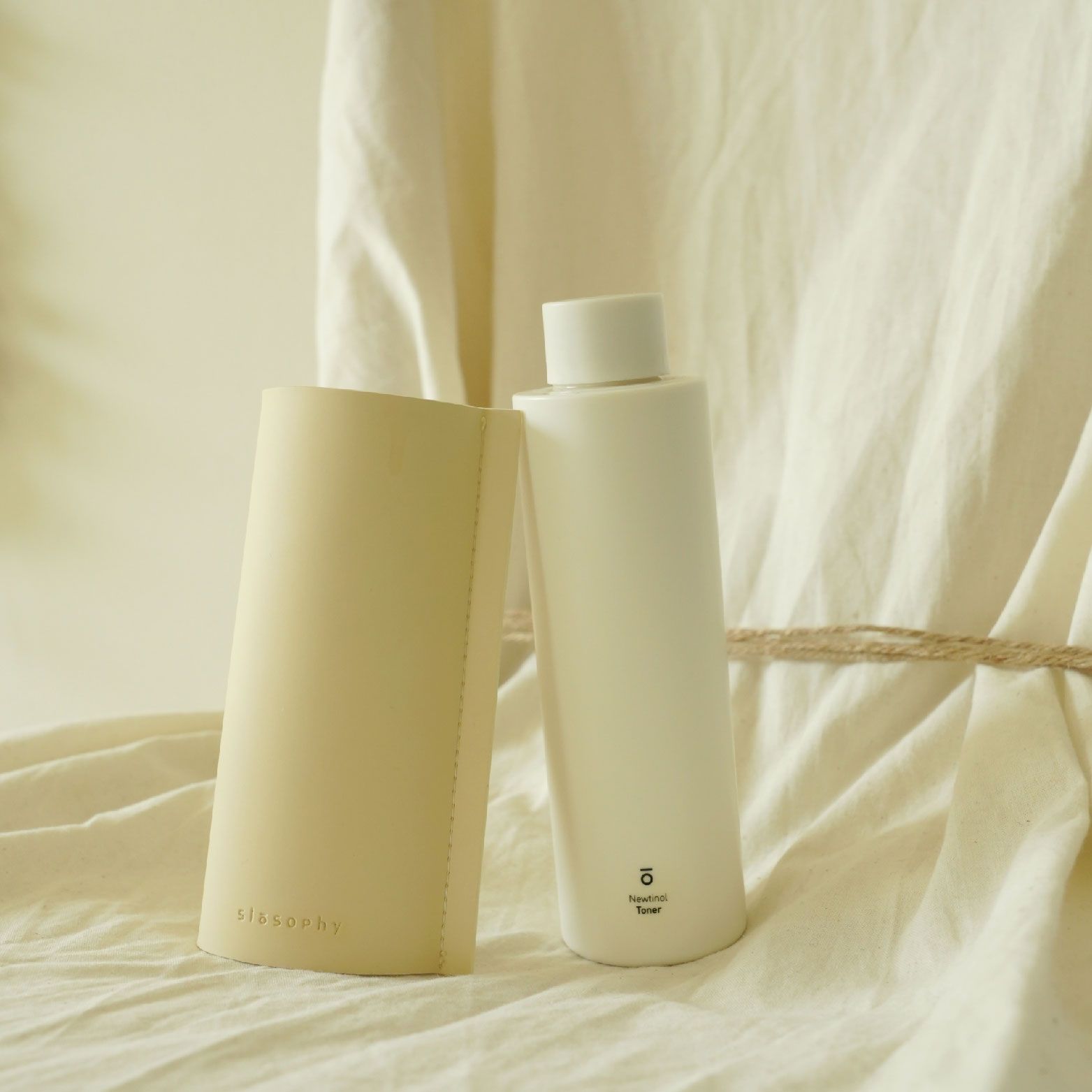 A 150ml bottle of Slosophy Newtinol Toner, promoting skin health with a contemporary and elegant packaging design.