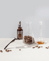  IOPE PDRN Caffeine Shot Ampoule 30ml/50ml in a transparent glass vial with a silver lid.