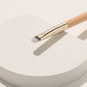 The brush head is tapered to allow for controlled blending and effortless distribution of product across the eyelid