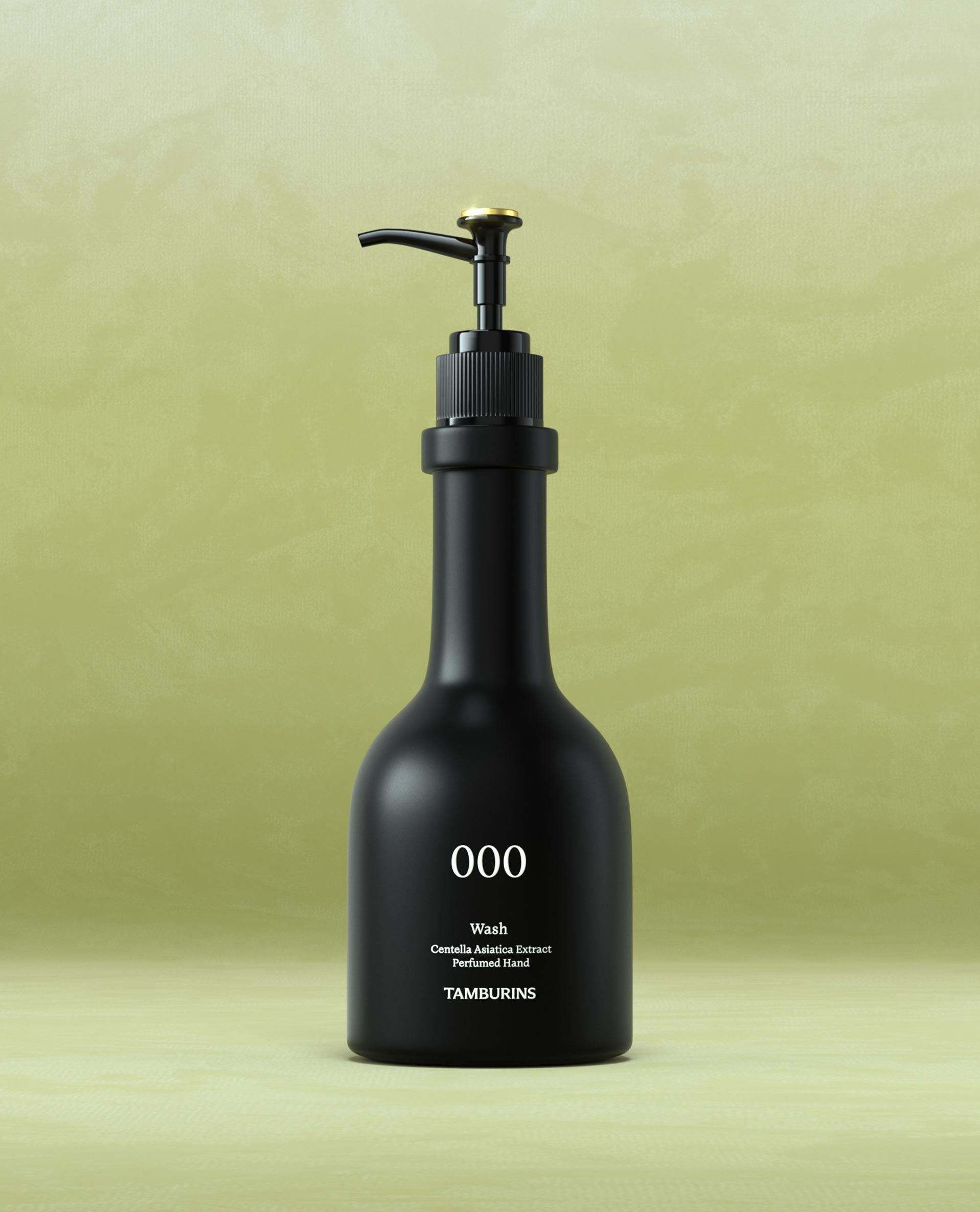 A sleek black pump bottle with a matte finish, labeled with the brand name "TAMBURINS" and the number "000" in white text. The bottom of the label lists the scents: bergamot, sandalwood, and patchouli. The bottle has a gold accent on the pump.