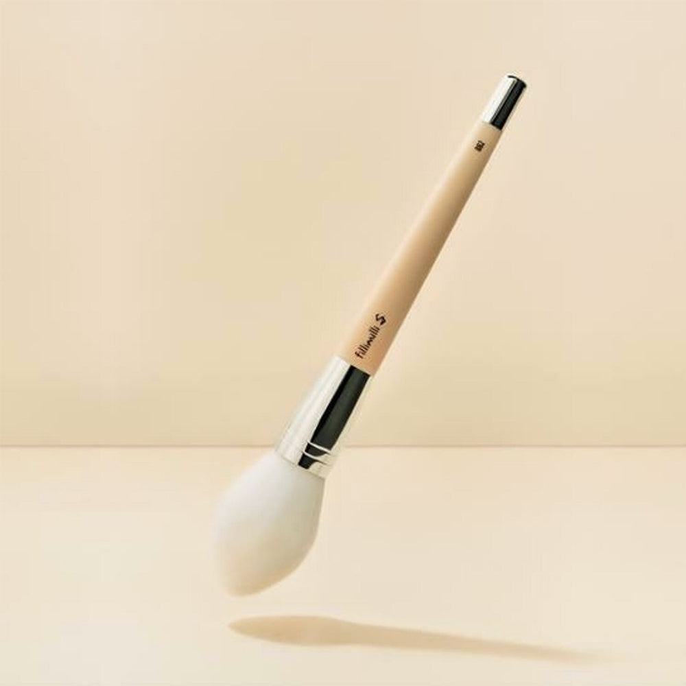 It features a medium-sized, soft brush head with silky, high-quality bristles that deliver a light, even layer of powder products, such as setting powders, bronzers, and blushes